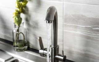 new and modern steel faucet in the kitchen